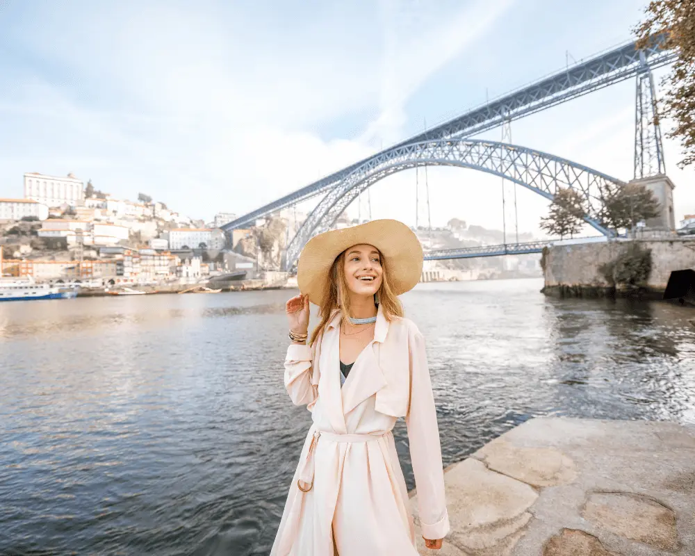 A woman standing in front of the a city view of Porto