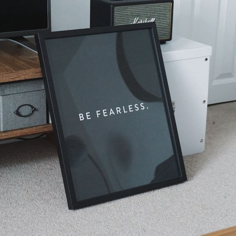 A photo frame with a caption inside saying "Be fearless"