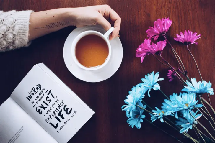 girl reading book empowering flower