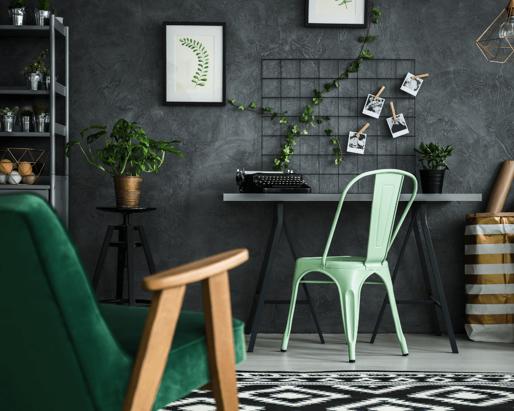 An office decorated in forest green with a grey textured feature wall