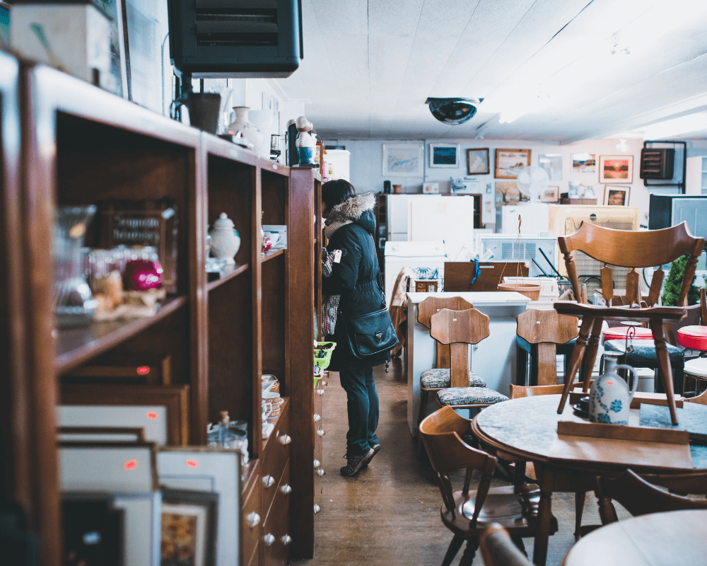 A woman shopping at a second hand furniture store