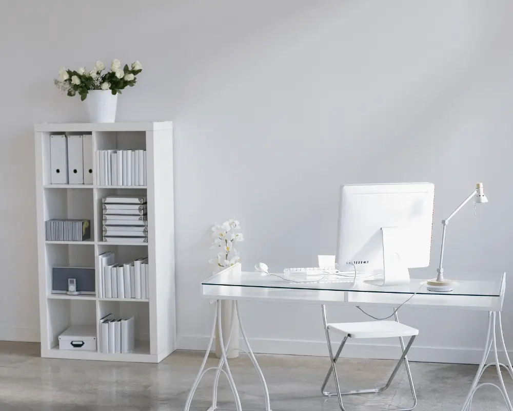An office decorated with clear perspex furniture and white office accessories