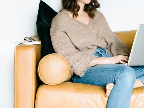 Woman on couch with laptop