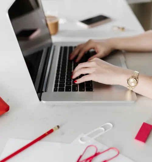 hands on laptop with stationary