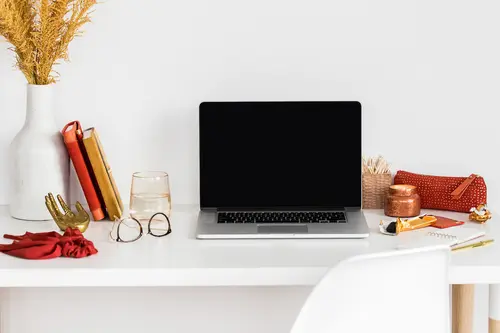Laptop on desk with orange and red details