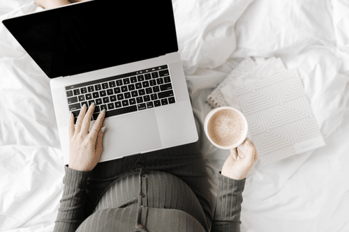 Pregnant woman with laptop and coffee