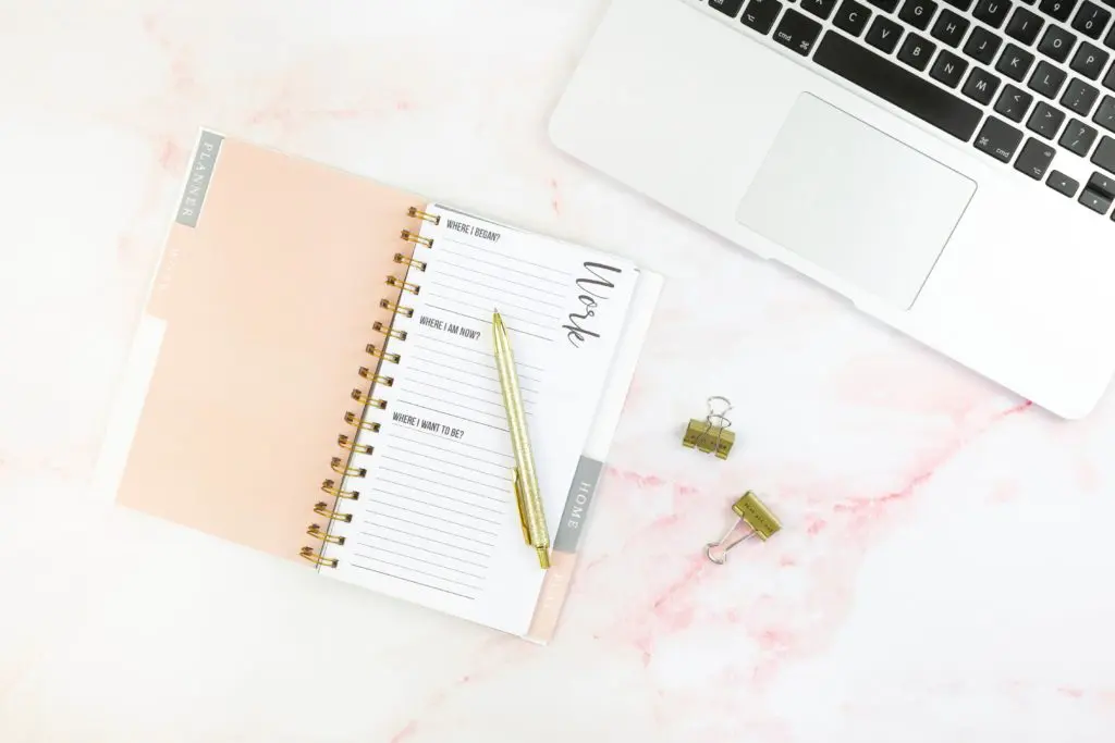 day planner with computer on desk