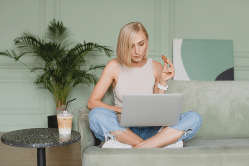 woman on couch working online