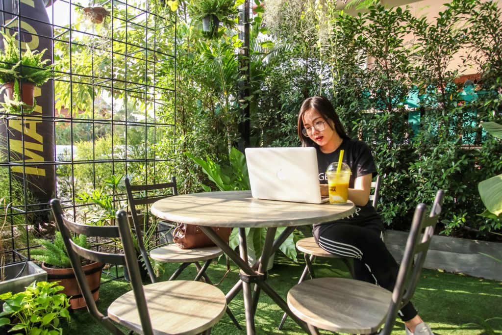 virtual assistant working from garden with smoothie