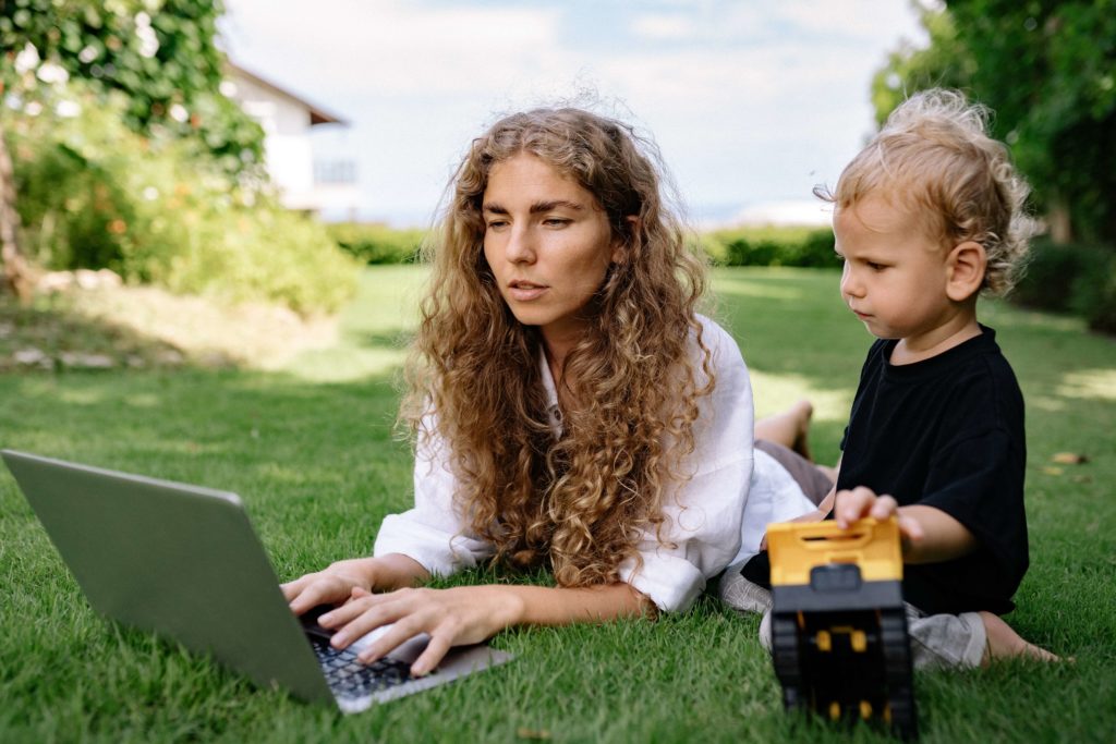 work from home mom working with son outdoors