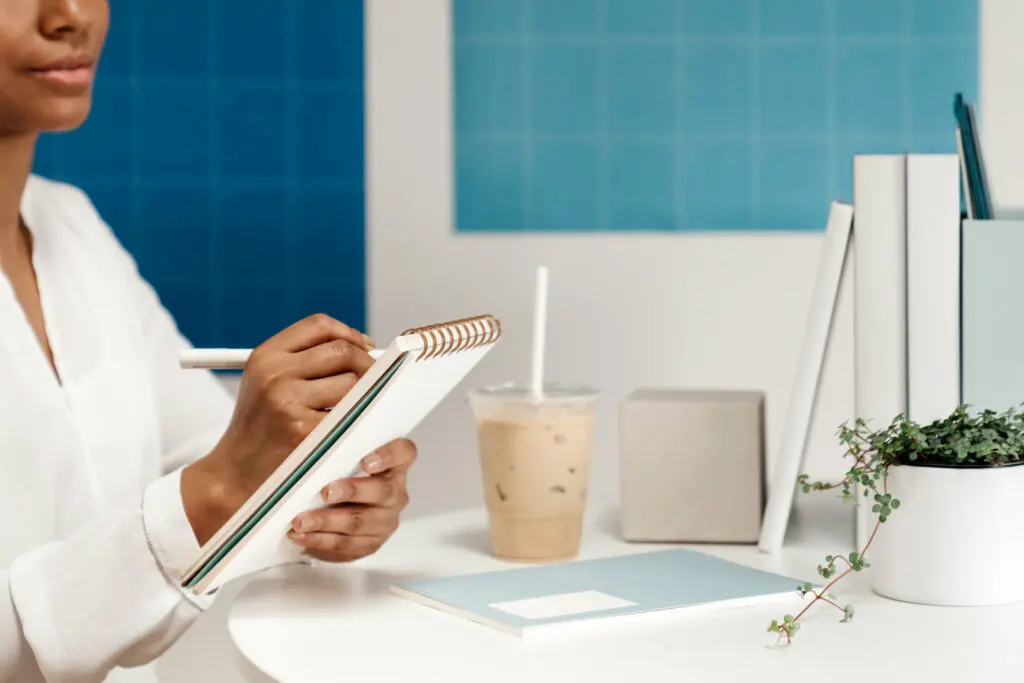 woman writing in notepad