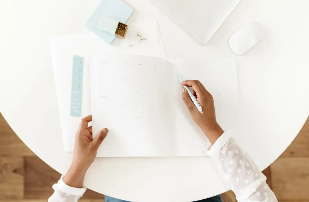 woman writing in calendar